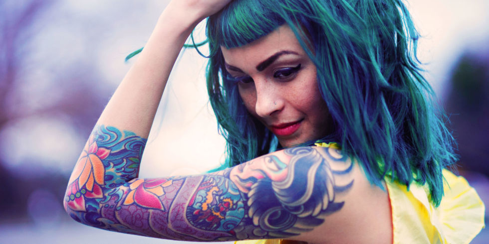 Woman with blue hair and tattoos